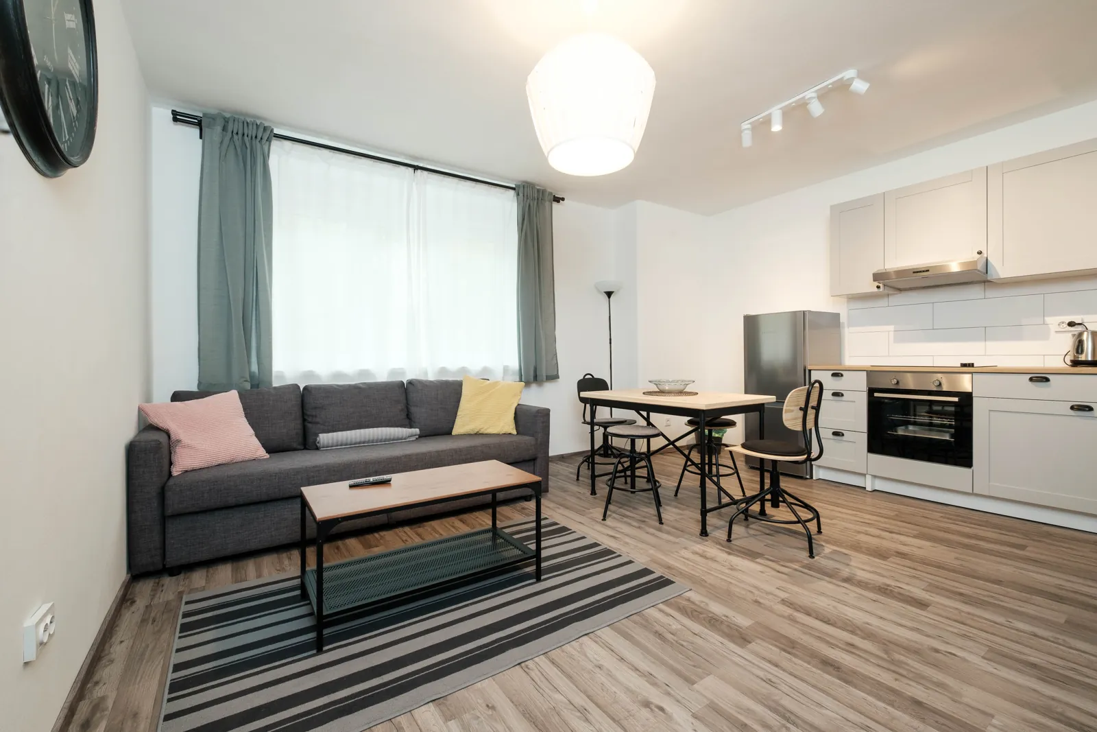 Living room with sofa, dining table and kitchen
